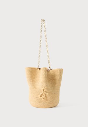 Beige woven bucket bag with a looped braided detail on the front and a gold chain shoulder strap.