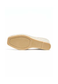 Semelle de sandale compensée, en caoutchouc beige, avec une surface texturée et un bord marron clair, arborant un motif ovale et une empreinte de taille.