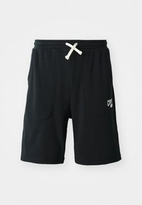 Black shorts made of soft fabric featuring an elastic waistband with a white drawstring, two front pockets, and a logo on the left leg.