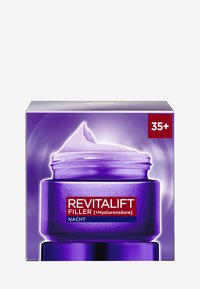 Pot de crème violet avec un couvercle à vis, présentant une surface texturée et une étiquette indiquant "REVITALIFT FILLER" avec un capuchon blanc et une indication d'utilisation nocturne.