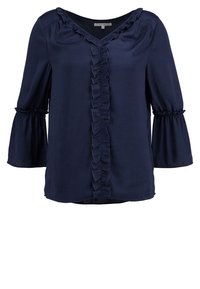 Marinblus, långärmad med V-ringning, med framsidan i volanger och ärmar som är utformade som klockor. Tillverkad av ett mjukt och slätt tyg.