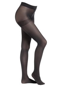 Collant neri in nylon trasparente indossati da un modello, che mettono in evidenza l'elastico stretto in vita per le donne in gravidanza.