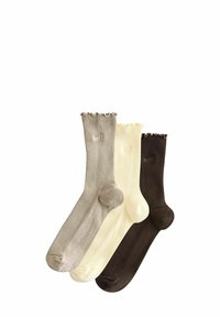 Set van drie paar sokken: lichtbeige, crème en donkerbruin. Ribbelstructuur met gegolfde toppen en geborduurde "zelf" details op twee paar.