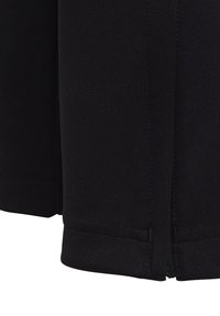 Vêtement en tissu noir avec une surface texturée, présentant une coupe droite, un ourlet cousu et un détail de fermeture à glissière sur le côté.