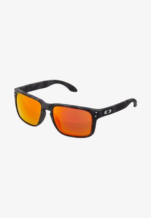 Lunettes de soleil noires en plastique avec des verres miroités orange. La monture a une finition légèrement brillante, de forme rectangulaire et avec un discret détail de logo.