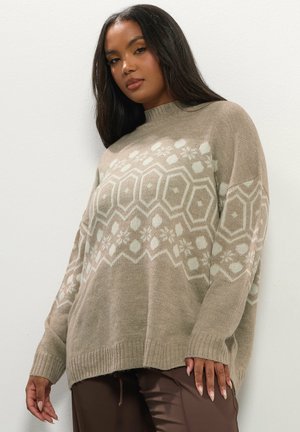 Beige knitted sweater with a high neck, featuring a geometric white pattern, loose fit, and ribbed cuffs and hem for texture.