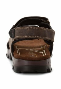 Braune Leder-Sandale mit verstellbaren Riemen und einem strukturierten Fußbett. Verfügt über eine robuste Laufsohle und kontrastierende Nähte.