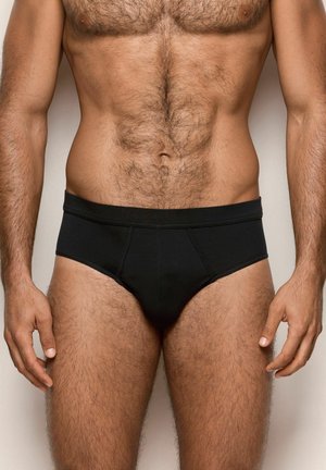 Boxers de algodón para hombre en color negro con una textura suave, cinturilla elástica y un diseño sencillo; cuentan con un panel frontal contorneado para mayor sujeción.