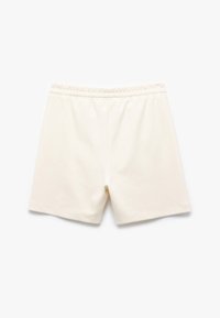 Crème-kleurige shorts met een elastische tailleband, met een gladde textuur en een losse pasvorm, ontworpen voor comfort. Geen zichtbare patronen of accenten.