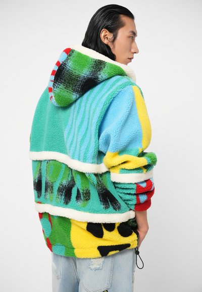 Fleece jacket featuring a multicolored design with shades of green, blue, and yellow, with a fluffy texture and striped hoodie.