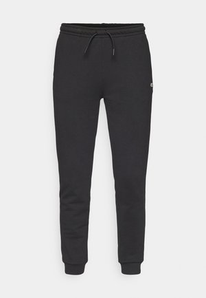 Schwarze Jogginghose aus weichem Material, mit einem elastischen Bund und Kordelzug sowie gerippten Bündchen. Dezentes Logo-Detail an der Seite.