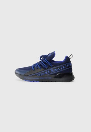 Blue athletic sneakers with mesh upper and rubber sole. Features include tonal laces, branding on the side, and contrasting black accents.