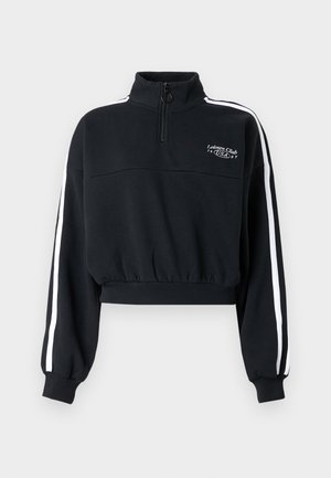 Sweatshirt noir court avec un col montant et une fermeture éclair au quart. Présente des bandes blanches sur les côtés et un petit logo brodé sur la poitrine.