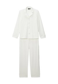 Ensemble de pyjama blanc en tissu doux ; comprend une chemise à col à boutons et un pantalon assorti avec des poignets et une taille élastiques.