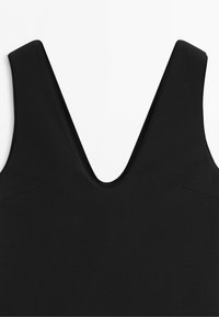 Black sleeveless top with wide shoulder straps and a deep V-neckline on a plain white background.
