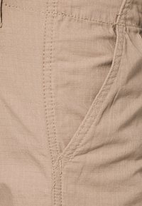 Urban Classics CAMOUFLAGE CARGO PANTS - Hlačami s stranskimi žepi - beige