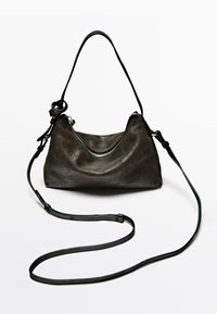 Borsa a spalla in pelle marrone scuro con texture, con zip sulla parte superiore e una tracolla lunga nera regolabile su uno sfondo bianco.
