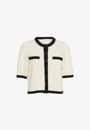 Īsām piedurknēm kardigāns, krēmkrāsā ar melnu apdari, ar pogu aizdari un divām priekšējām kabatām. Mīksta tekstūra un kastes formas.