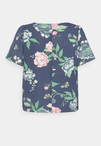 Blusa floral com mangas curtas, fundo azul-marinho, flores em rosa claro e verde, tecido suave, gola redonda e design com as costas abertas.