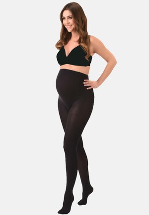 Black maternity tights featuring a high waistband, smooth texture, and full-length design. Model posed to showcase fit and style.