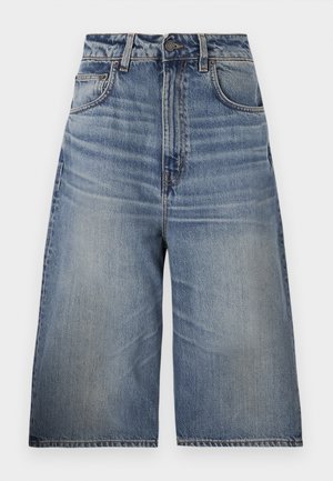 Blue denim culottes with a high waist, relaxed fit, light blue wash, front pockets, visible stitching, and button closure at the waist.