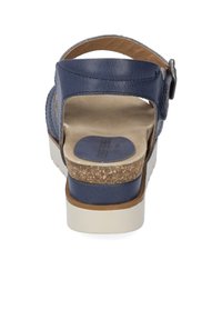 Navy blue sandal with an adjustable ankle strap, cork-wrapped midsole, and textured leather upper. Features a cushioned footbed for comfort.