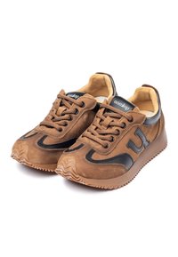 Brown suede sneakers with black accents, round toe, and lace-up closure. Textured rubber sole with zigzag pattern. Logo on tongue.