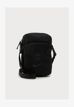 Kompakt sort crossbody taske med front lynlåslomme, justerbar rem, Paris Saint-Germain logo og Nike swoosh på frontpanelet.