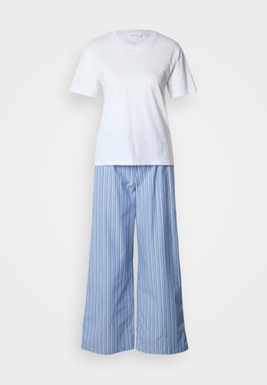 White cotton t-shirt paired with blue and white striped wide-leg pants, featuring a loose fit and soft texture.