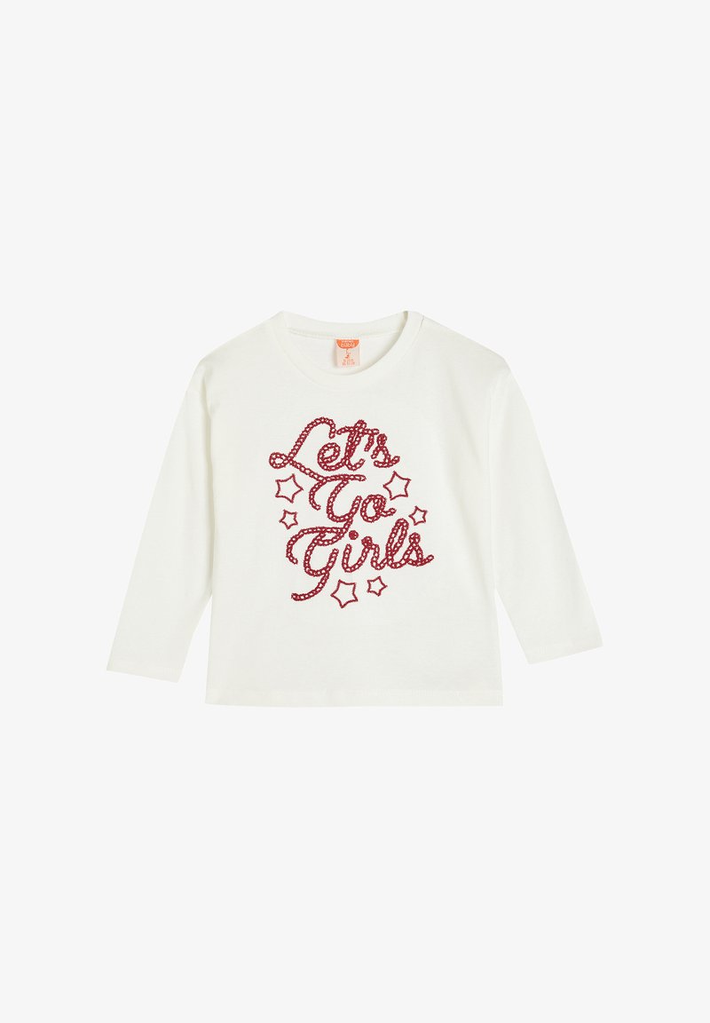 Valkoinen pitkähihainen t-paita, jossa on punaisella kimaltelevaan kursiivikirjoitukseen "Let's Go Girls" ja tähtikoristeita, valmistettu pehmeästä puuvillakankaasta.