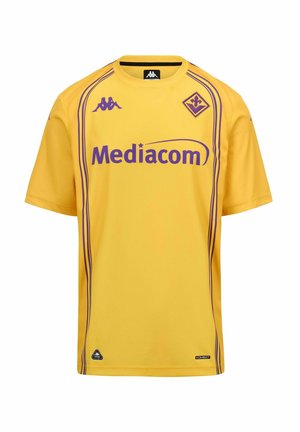 Maillot de sport jaune avec logo Mediacom violet, logos de la marque Kappa et emblème violet du club de football Fiorentina.