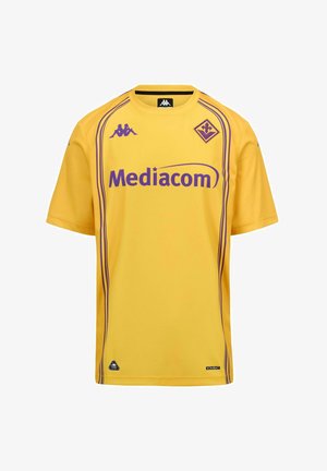 Maglia sportiva gialla con logo Mediacom viola, loghi del marchio Kappa e stemma viola del club di calcio Fiorentina.