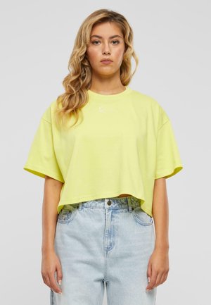 Bright yellow cropped t-shirt in soft cotton with a round neckline and short sleeves, featuring minimal white embroidered detailing.