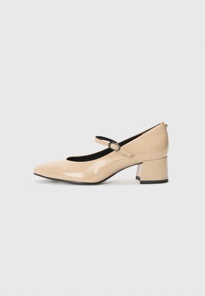 Beige patenttihuiset Mary Jane -kengät, joissa on valevarvas, soljettihihna ja keskipitkä lohkokorko. Sileä pinta kiiltävällä viimeistelyllä.