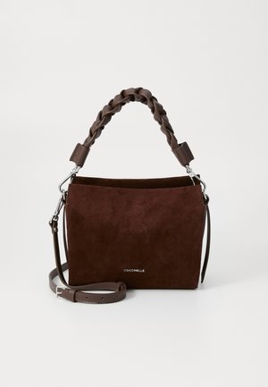 Brown suede handbag with a braided handle, flat shape, magnetic closure, and an adjustable strap. Features a logo on the front.
