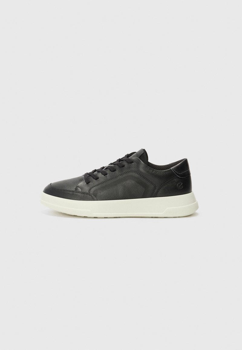 Black leather sneaker with a textured upper, cream rubber sole, round toe, and black lace closure. Features a subtle logo on the side.