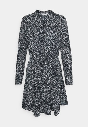 Zwarte lange mouwen jurk met kleine witte bloemenprint, getailleerde taille en uitlopende rok.