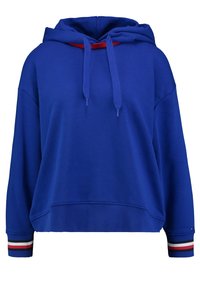 Modrá mikina s kapucí z bavlněné směsi. Má červený stahovací šňůrku, zkrácený střih a proužkované akcenty v červené, bílé a modré barvě na rukávech.