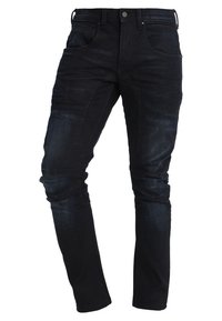 Mörkblå jeans i denim med slim fit, som har framfickor, en medelhög midja och minimalistiska sömnadsdetaljer längs sömmarna.
