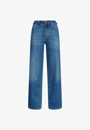 Laiad sinised teksad, mis on valmistatud denimist, omavad klassikalist lõiget kõrgema vöökoha, ees olevate taskute ja pehme tuhmumisega, et anda tekstuuri.