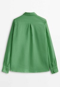 Long-sleeve green shirt with buttoned cuffs, collar, and a central back pleat, displayed flat against a white background.