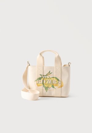 Small beige canvas tote with short handles and long strap, featuring a lemon and the text "Italia Riviera Portofino Hugo" on the front.