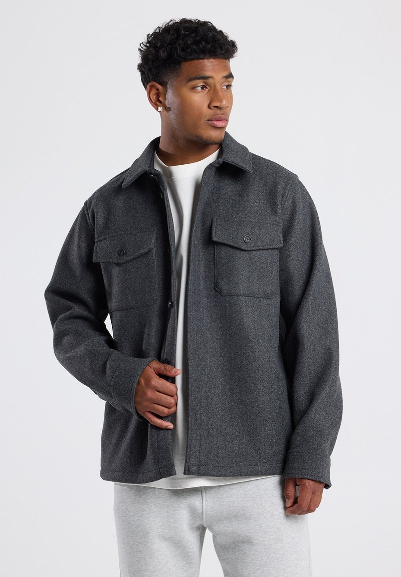Gray wool blend jacket with two chest pockets, button closures, and a regular fit. Soft texture with a classic shirt collar design.