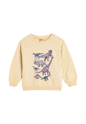 Bawełnowa bluza w jasnym beżu z kolorowymi ilustracjami dinozaurów na przodzie. Rękawy i dół wykończone ściągaczem, z okrągłym dekoltem.