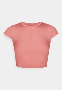 Rövid ujjú, világos rózsaszín crop top, texturált anyagból készült, kerek nyakkivágással. A mellrészen egy kis fehér Nike logó található.