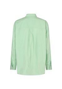 Chemise à manches longues vert clair avec un col à boutons, dotée d'un plissé au dos et de boutons aux poignets. Tissu lisse.