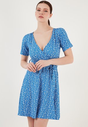 Blue wrap dress with short sleeves, floral white patterns, V-neckline, waist tie, and soft, lightweight fabric.