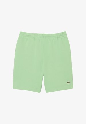 Pantaloni sportivi verde chiaro realizzati in tessuto morbido. Presentano un elastico in vita e un piccolo logo sulla parte inferiore sinistra.