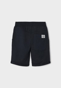 Navy blue cotton shorts with a waistband, rolled cuffs, a back pocket, and a label. Smooth texture with subtle stitching details.
