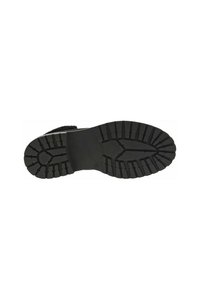 Semelle de chaussure en caoutchouc noir avec un motif de semelle profond pour une adhérence, comportant une surface lisse près du centre et des bords texturés.